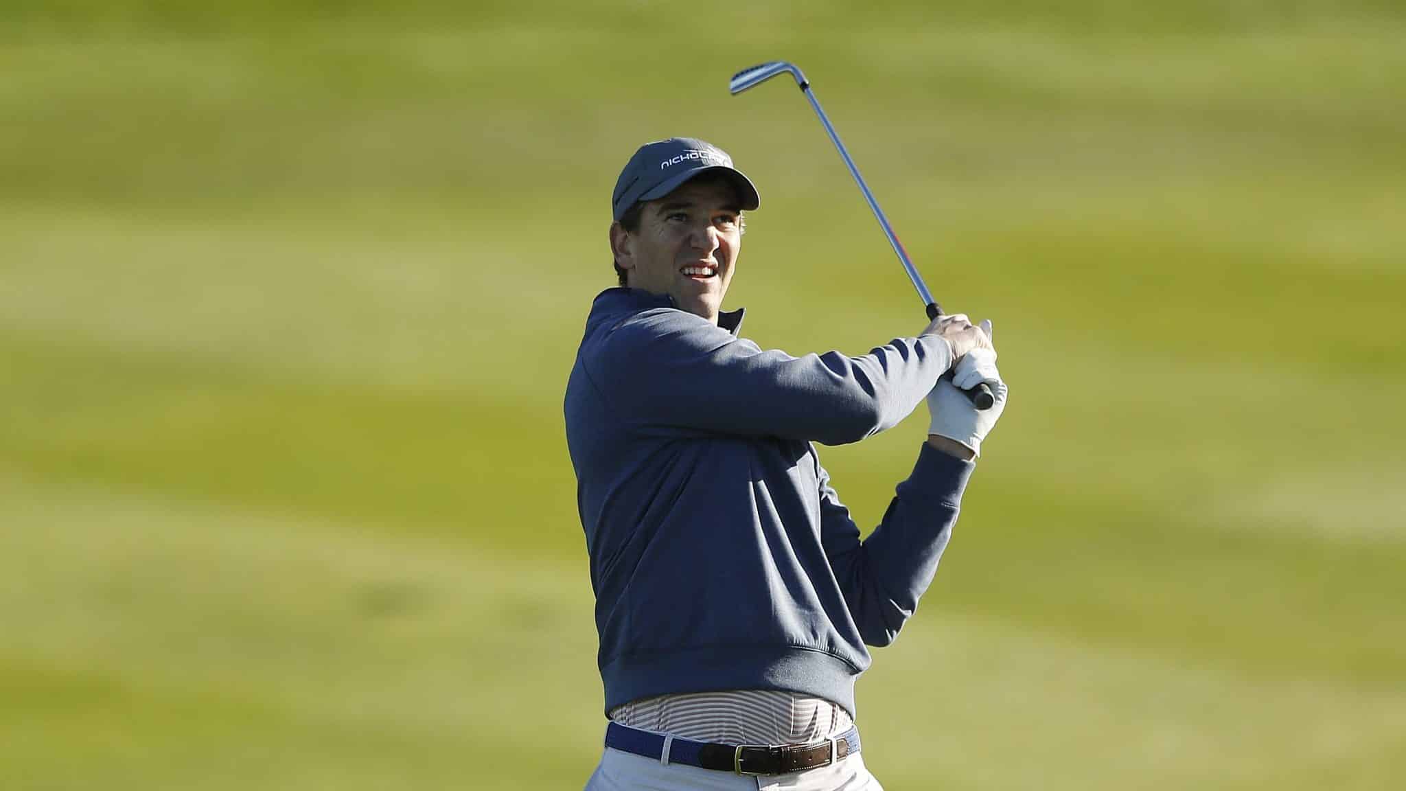 PEBBLE BEACH, CALIFORNIA - FEBRUARY 06: Former NFL player Eli Manning plays a shot on the second hole during the during the first round of the AT&T Pebble Beach Pro-Am at Spyglass Hill Golf Course on February 06, 2020 in Pebble Beach, California.