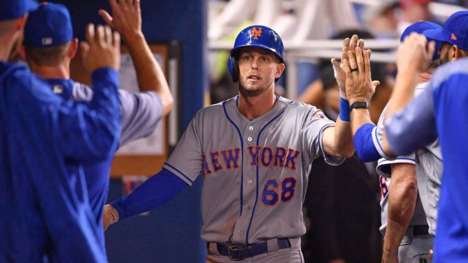 MIAMI, FL - AUGUST 10: Jeff McNeil #68 of the New York Mets celebrates with teammates in the dugout after scoring a run in the third inning against the Miami Marlins at Marlins Park on August 10, 2018 in Miami, Florida.