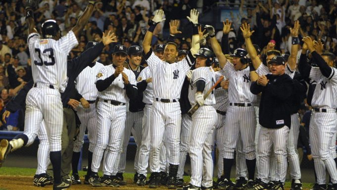 21 Oct 2001: Alfonso Soriano of the New York Yankees is met by his teammates at home plate after hitting the game winning home run against Kazuhiro Sasaki of the Seattle Mariners in game four of the American League Championship Series at Yankee Stadium, in the Bronx, New York.