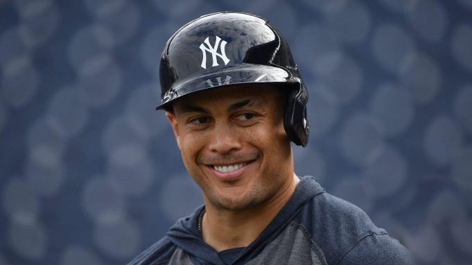 TAMPA, FLORIDA - FEBRUARY 24: Giancarlo Stanton #27 of the New York Yankees smiling with teammates during batting practice prior to the spring training game against the Pittsburgh Pirates at Steinbrenner Field on February 24, 2020 in Tampa, Florida.