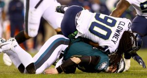 PHILADELPHIA, PENNSYLVANIA - JANUARY 05: Quarterback Carson Wentz #11 of the Philadelphia Eagles is hit by Jadeveon Clowney #90 of the Seattle Seahawks during the NFC Wild Card Playoff game at Lincoln Financial Field on January 05, 2020 in Philadelphia, Pennsylvania.