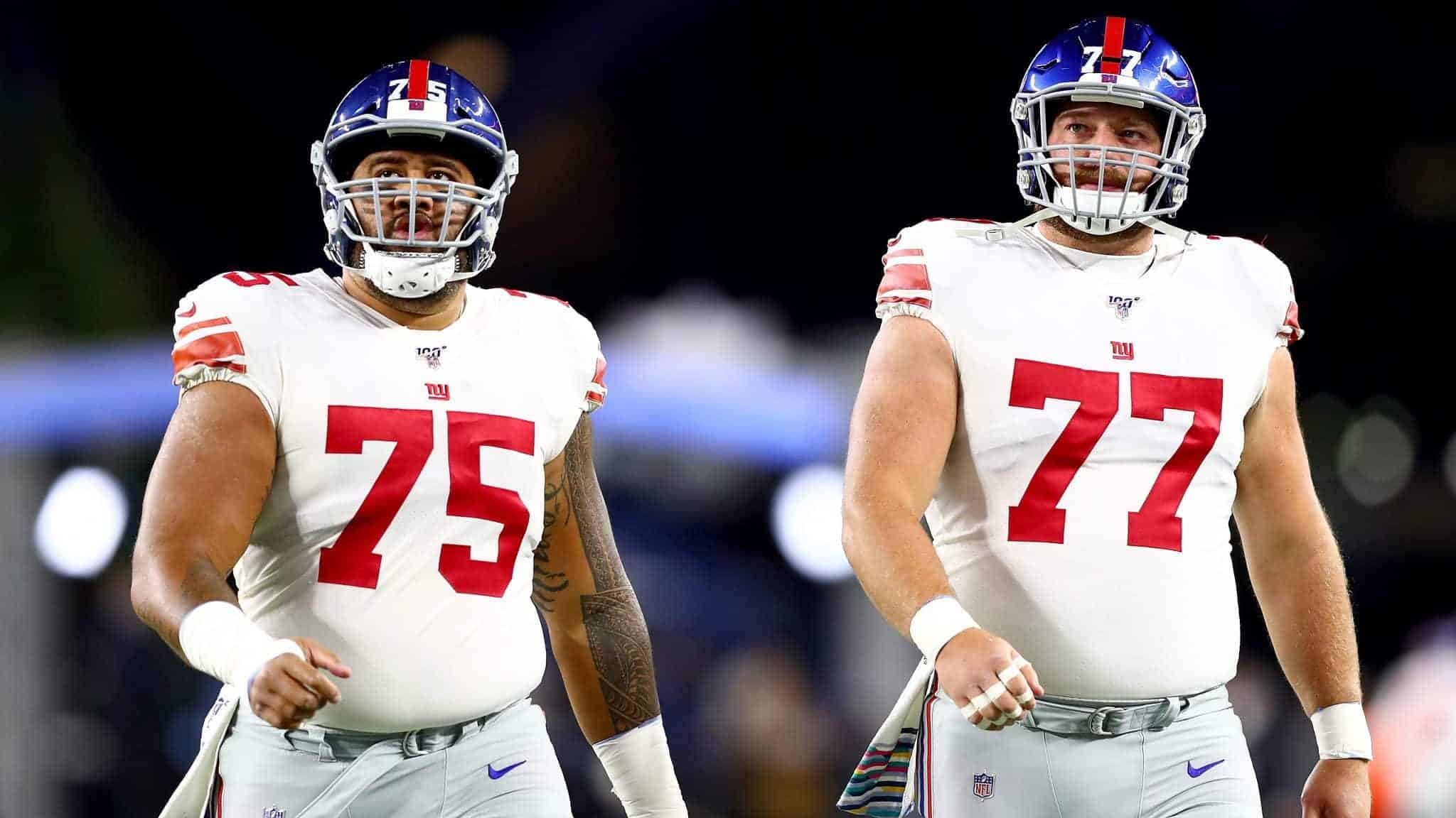 FOXBOROUGH, MASSACHUSETTS - OCTOBER 10: Jon Halapio #75 and Spencer Pulley #77 of the New York Giants look on prior to the game against the New England Patriots at Gillette Stadium on October 10, 2019 in Foxborough, Massachusetts.