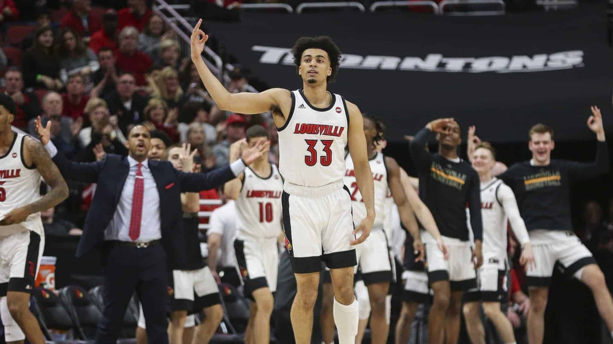 LOUISVILLE, KENTUCKY - FEBRUARY 08: Jordan Nwora #33 of the Louisville Cardinals celebrates after making a three-point shot against the Virginia Cavaliers during the first half of the game at KFC YUM! Center on February 08, 2020 in Louisville, Kentucky.
