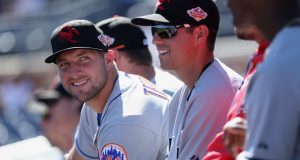 PEORIA, AZ - OCTOBER 13: Tim Tebow #15 (New York Mets) of the Scottsdale Scorpions watches from the dugout during the Arizona Fall League game against the Peoria Javelinas at Peoria Stadium on October 13, 2016 in Peoria, Arizona.