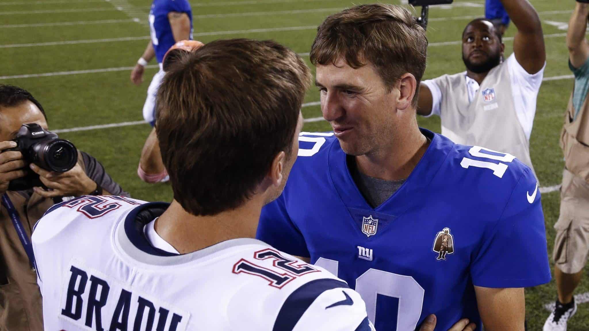 EAST RUTHERFORD, NJ - AUGUST 30: Eli Manning #10 of the New York Giants greets Tom Brady #12 of the New England Patriots after a pre-season NFL game at MetLife Stadium on August 30, 2018 in East Rutherford, New Jersey.