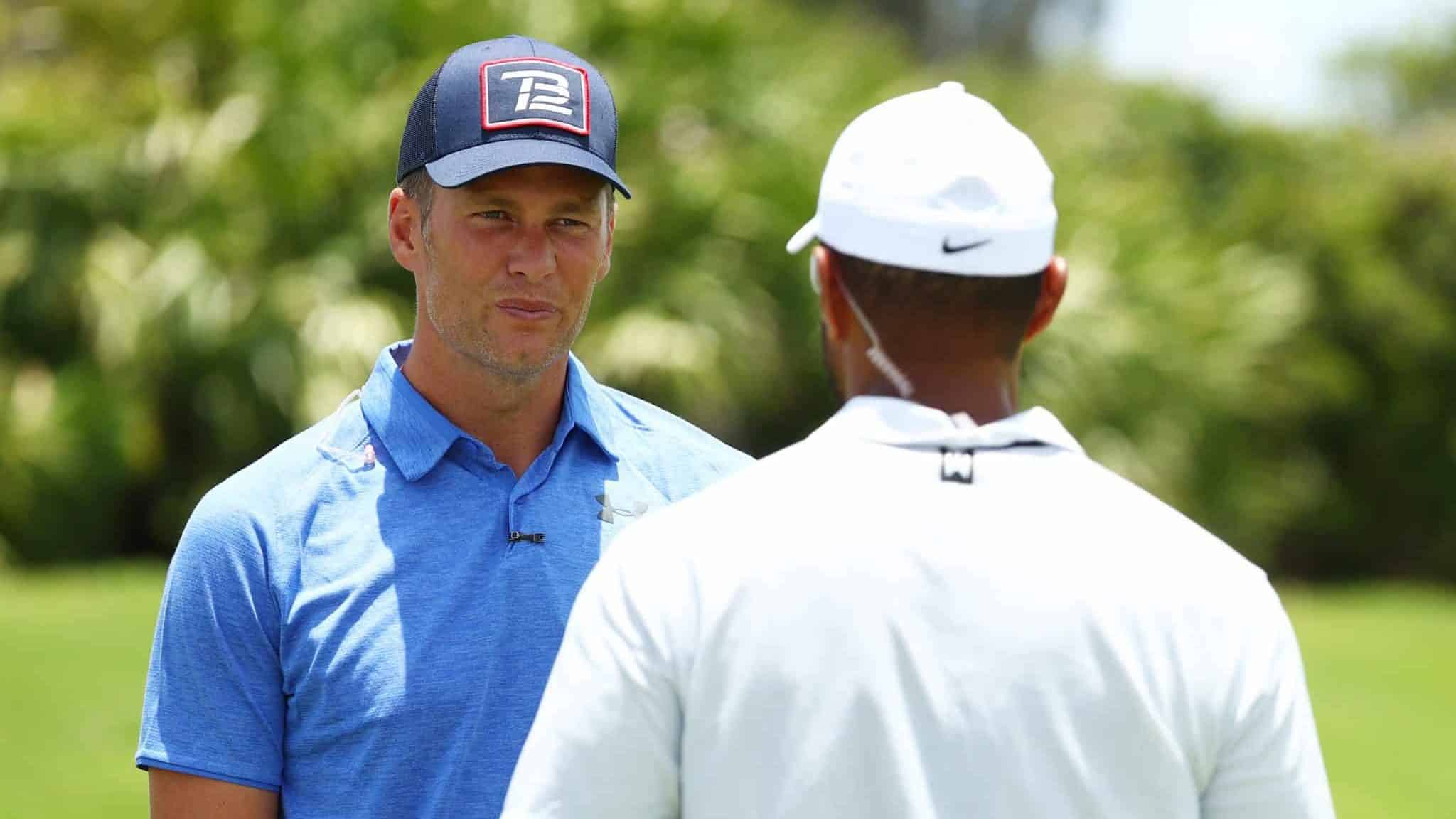 HOBE SOUND, FLORIDA - MAY 23: NFL player Tom Brady of the Tampa Bay Buccaneers talks to Tiger Woods during a practice round for The Match: Champions For Charity at Medalist Golf Club on May 23, 2020 in Hobe Sound, Florida.