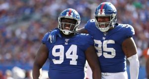 EAST RUTHERFORD, NEW JERSEY - SEPTEMBER 29: Dalvin Tomlinson #94 and B.J. Hill #95 of the New York Giants celebrates a sack of Dwayne Haskins #7 of the Washington Redskins during their game at MetLife Stadium on September 29, 2019 in East Rutherford, New Jersey.