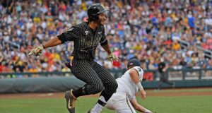 OMAHA, NE - JUNE 25: Austin Martin #16 of the Vanderbilt Commodores gets thrown out at first base in the third inning against the Michigan Wolverines during game two of the College World Series Championship Series on June 25, 2019 at TD Ameritrade Park Omaha in Omaha, Nebraska. MLB Draft