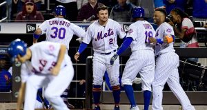 NEW YORK, NEW YORK - SEPTEMBER 24: Michael Conforto #30 and Rajai Davis #18 are congratulated by teammates Robinson Cano #24 and J.D. Davis #28 of the New York Mets after a two run home run in the ninth inning of their game against the Miami Marlins at Citi Field on September 24, 2019 in the Flushing neighborhood of the Queens borough of New York City.