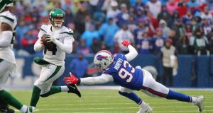ORCHARD PARK, NY - DECEMBER 29: Sam Darnold #14 of the New York Jets looks to throw a pass as Trent Murphy #93 of the Buffalo Bills dives to try and make a tackle during the first half at New Era Field on December 29, 2019 in Orchard Park, New York.
