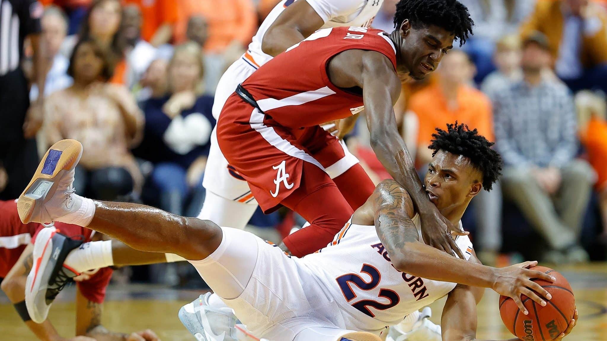 AUBURN, ALABAMA - FEBRUARY 12: Allen Flanigan #22 of the Auburn Tigers grabs a loose ball against Kira Lewis Jr. #2 of the Alabama Crimson Tide in the second half at Auburn Arena on February 12, 2020 in Auburn, Alabama.