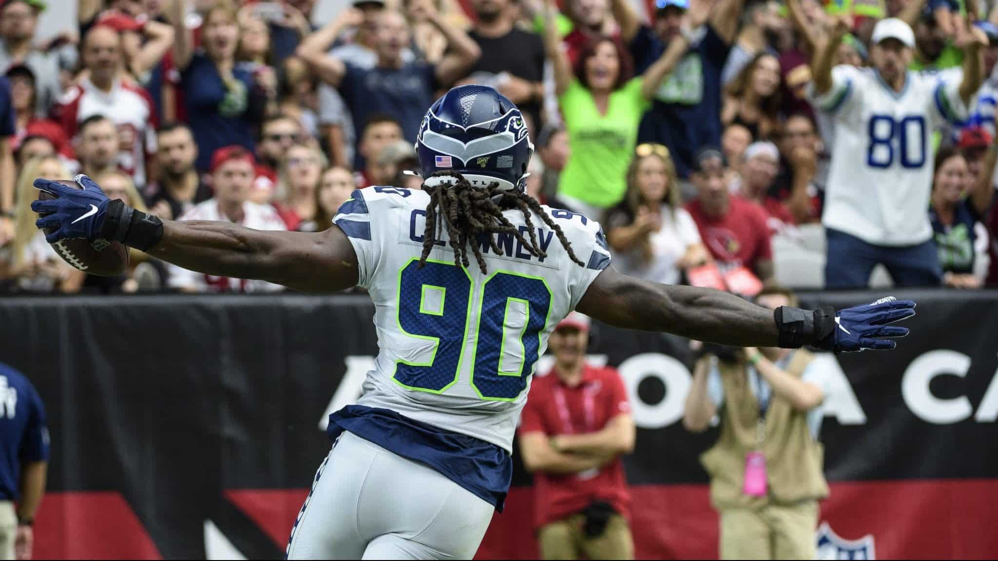 GLENDALE, ARIZONA - SEPTEMBER 29: Outside linebacker Jadeveon Clowney #90 of the Seattle Seahawks runs in an interception for a touchdown in the first half of the NFL game against the Arizona Cardinals at State Farm Stadium on September 29, 2019 in Glendale, Arizona.