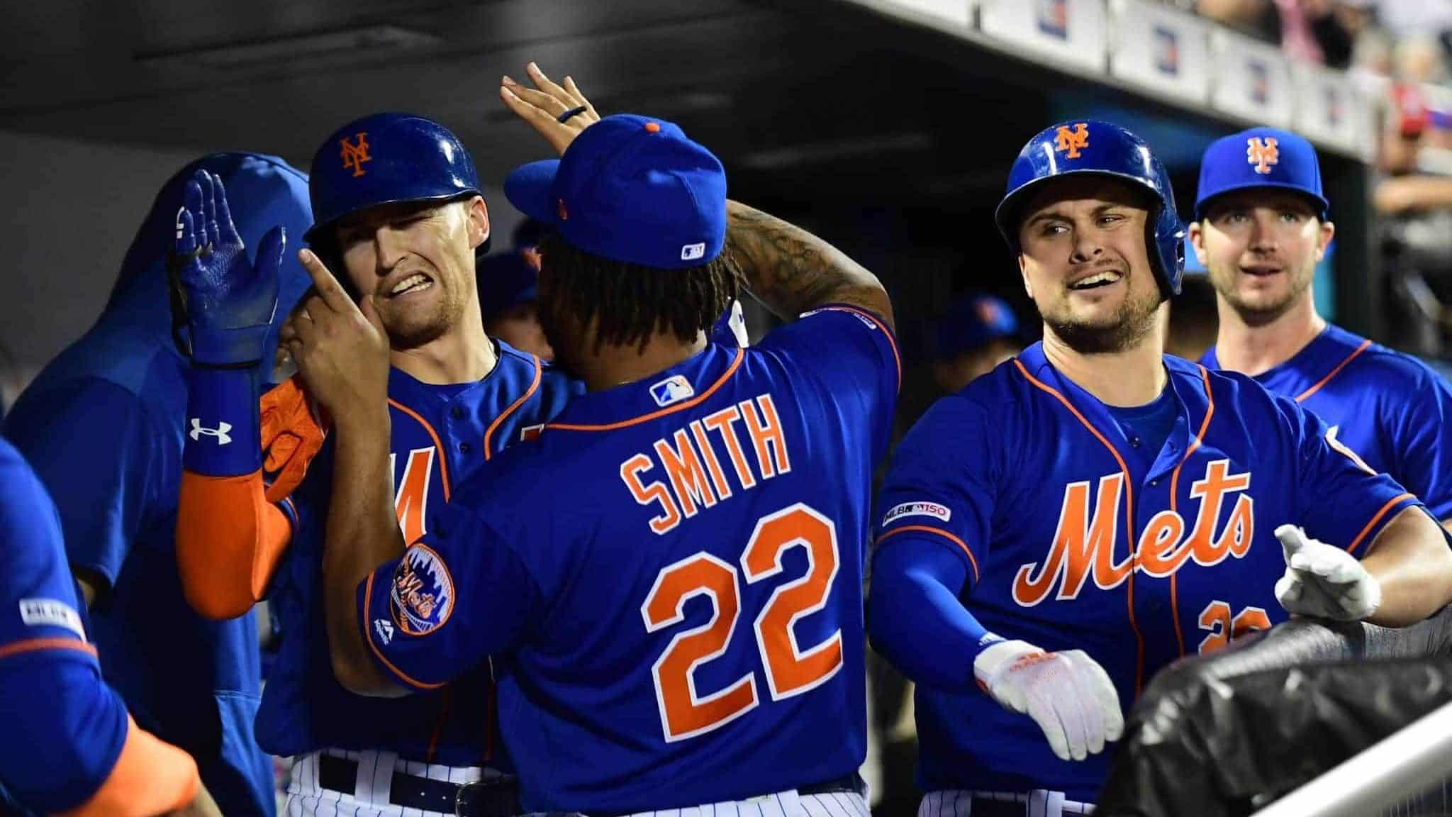 NEW YORK, NEW YORK - SEPTEMBER 27: J.D. Davis #28 and Dominic Smith #22 of the New York Mets celebrate after Davis's home run in the fourth inning of their game against the Atlanta Braves at Citi Field on September 27, 2019 in the Flushing neighborhood of the Queens borough of New York City.