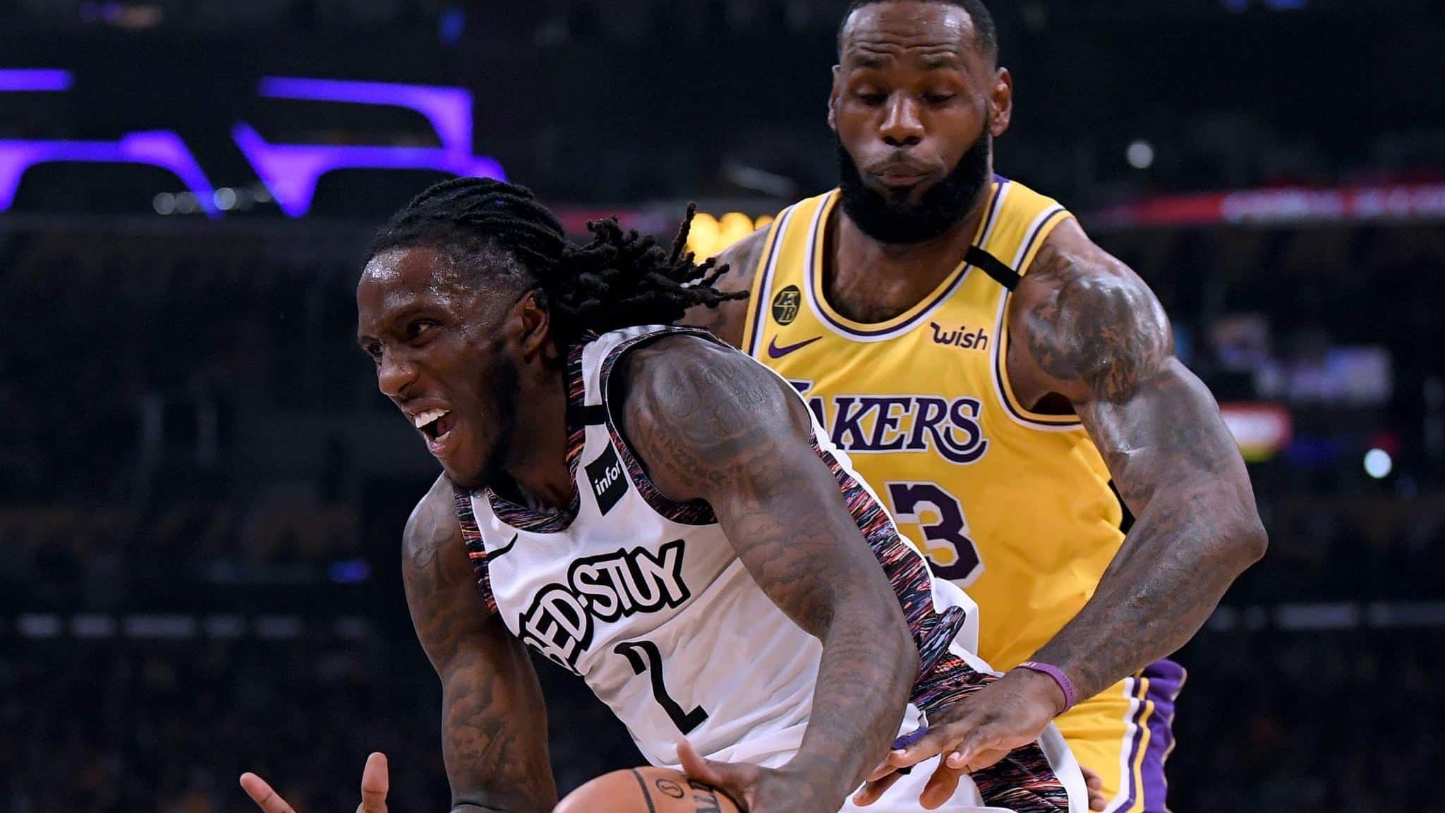 LOS ANGELES, CALIFORNIA - MARCH 10: Taurean Prince #2 of the Brooklyn Nets dribbles past LeBron James #23 of the Los Angeles Lakers during the first half at Staples Center on March 10, 2020 in Los Angeles, California.