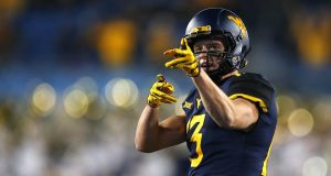 MORGANTOWN, WV - OCTOBER 25: David Sills V #13 of the West Virginia Mountaineers reacts after a first down in the first half against the Baylor Bears at Mountaineer Field on October 25, 2018 in Morgantown, West Virginia.