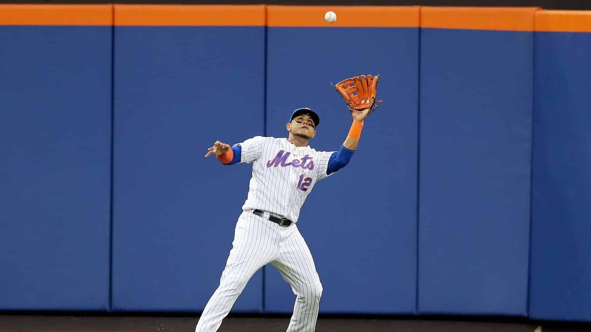 NEW YORK, NEW YORK - AUGUST 21: Juan Lagares #12 of the New York Mets makes the catch for the out in the first inning against the Cleveland Indians at Citi Field on August 21, 2019 in the Flushing neighborhood of the Queens borough of New York City.
