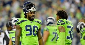 SEATTLE, WASHINGTON - OCTOBER 03: Jadeveon Clowney #90 and Bradley McDougald #30 of the Seattle Seahawks have a chat during a timeout of the game against the Los Angeles Rams at CenturyLink Field on October 03, 2019 in Seattle, Washington. The Seattle Seahawks top the Los Angeles Rams 30-29. New York Jets