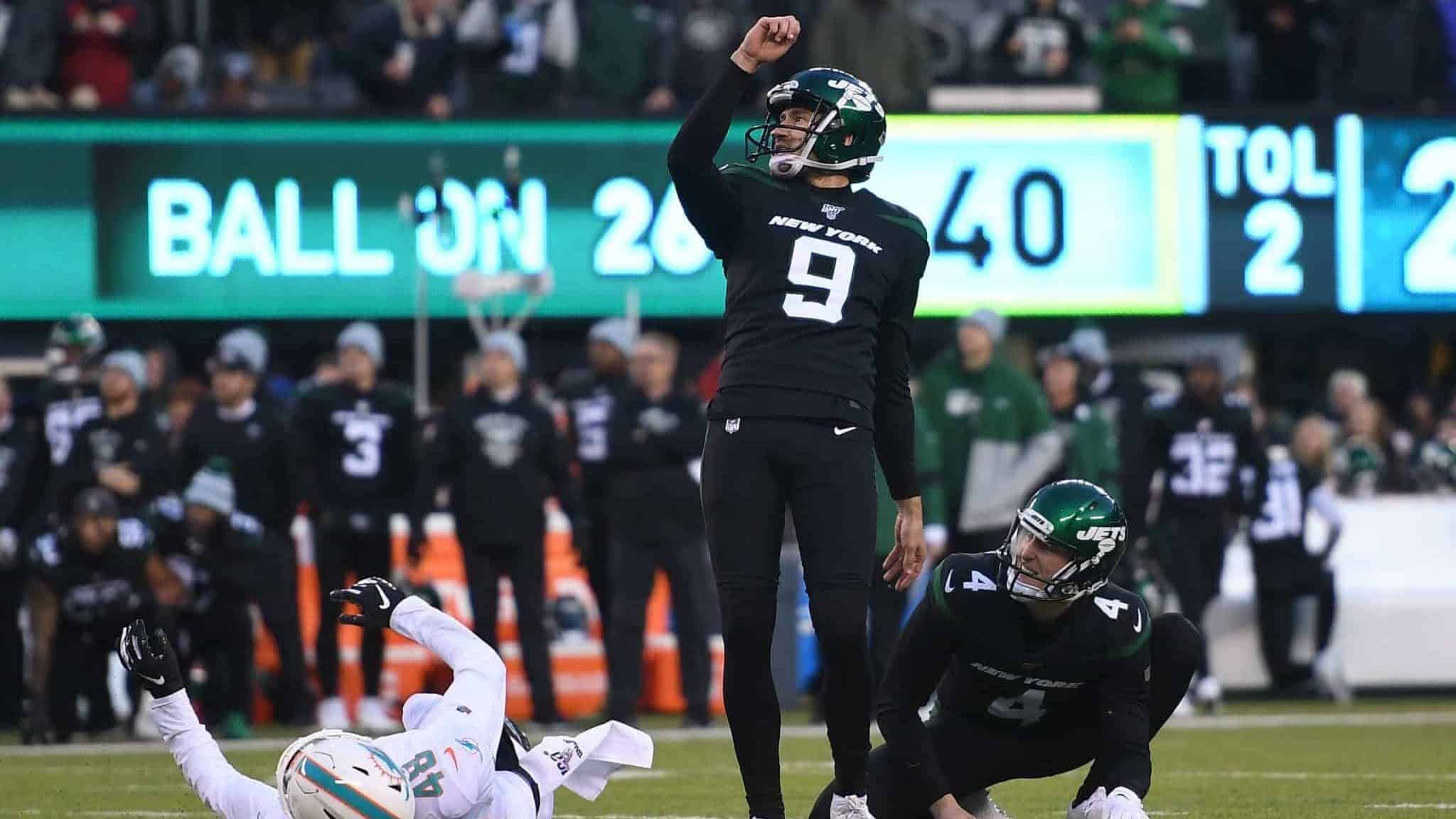 EAST RUTHERFORD, NEW JERSEY - DECEMBER 08: Sam Ficken #9 of the New York Jets kicks the game-winning field goal as Lac Edwards #4 placeholds during the second half of the game against the Miami Dolphins at MetLife Stadium on December 08, 2019 in East Rutherford, New Jersey. The New York Jets defeat the Miami Dolphins 22-21.