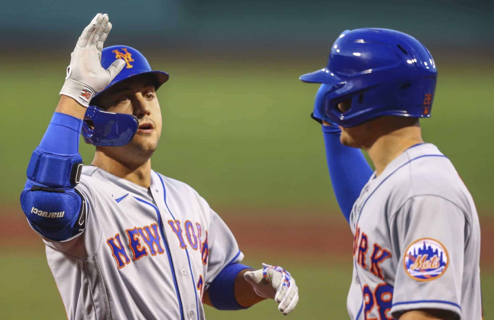 BOSTON, MA - JULY 27: Michael Conforto #30 of the New York Mets high fives J.D. Davis #28 after hitting a two-run home run in the second inning of a game against the Boston Red Sox at Fenway Park on July 27, 2020 in Boston, Massachusetts.
