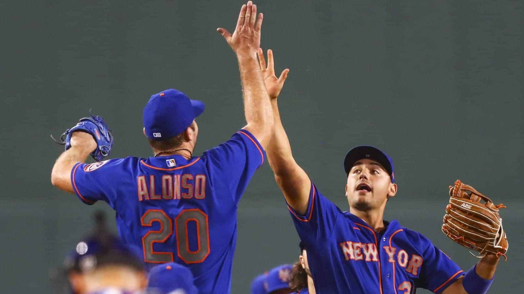 BOSTON, MA - JULY 28: Pete Alonso #20 of the New York Mets high fives Michael Conforto #30 after a victory over the Boston Red Sox at Fenway Park on July 28, 2020 in Boston, Massachusetts.