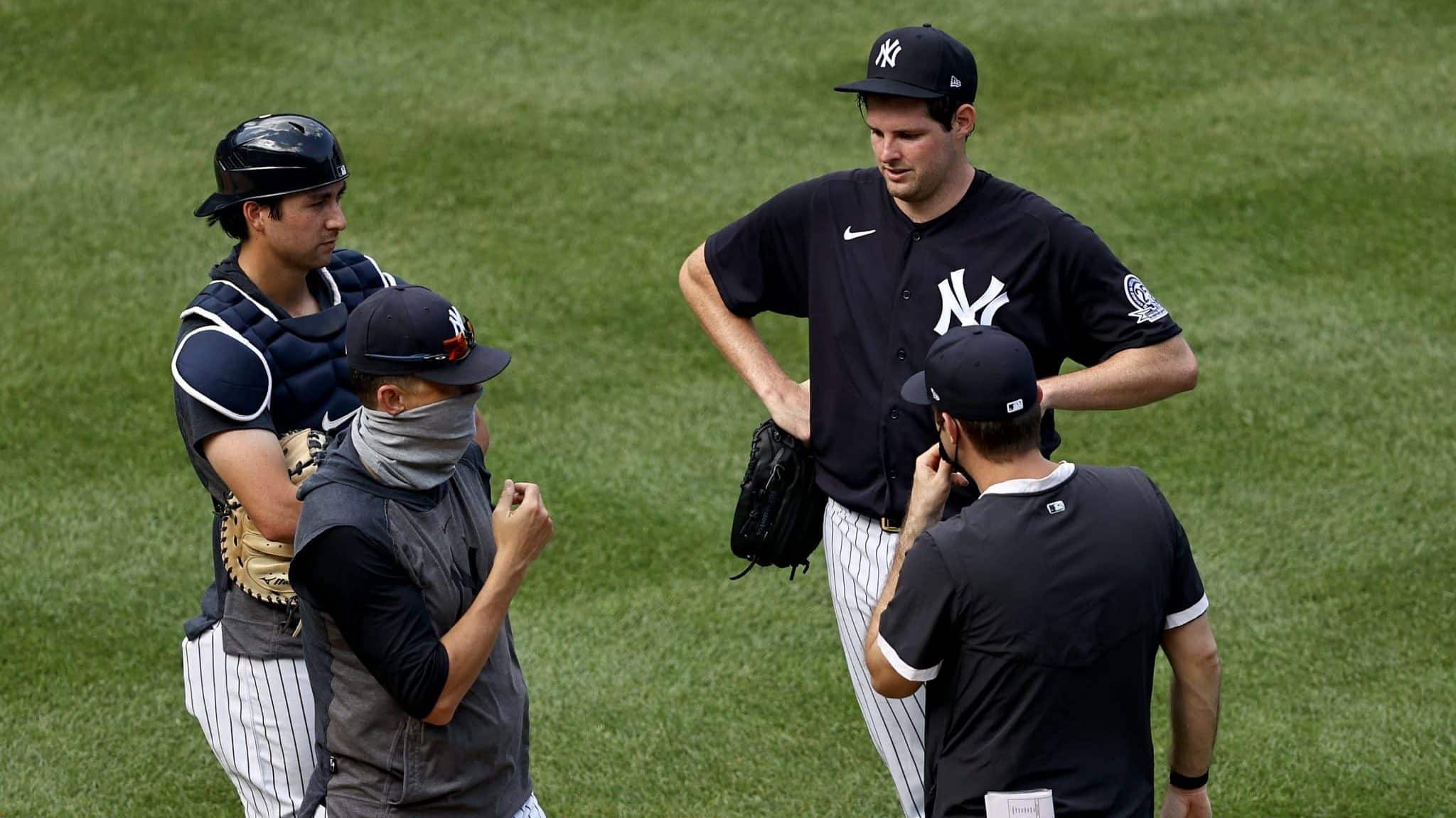 NEW YORK, NEW YORK - JULY 04: Manager Aaron Boone talks with Jordan Montgomery #47 of the New York Yankees during summer workouts at Yankee Stadium on July 04, 2020 in the Bronx borough of New York City.