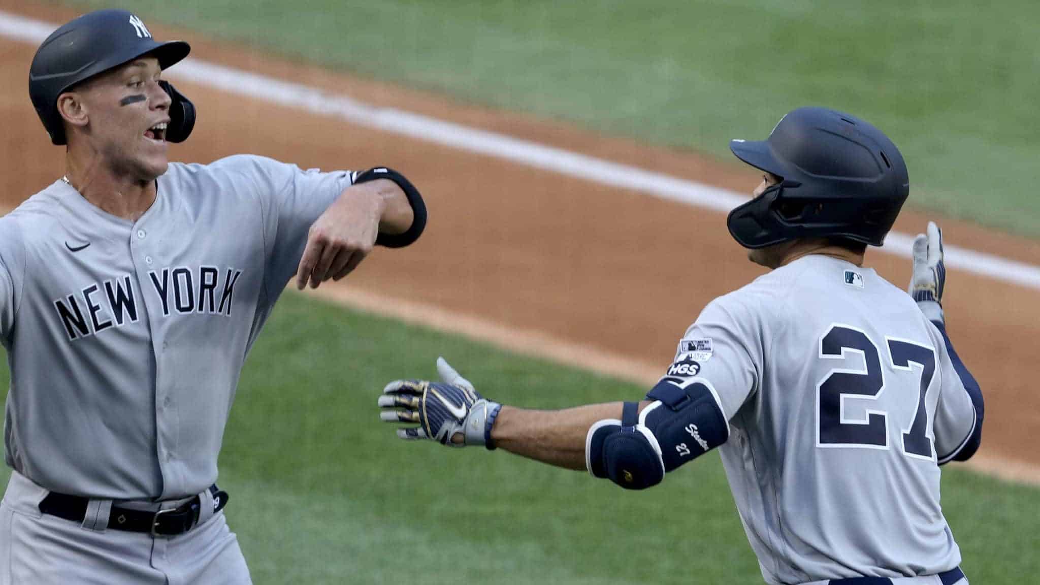 WASHINGTON, DC - JULY 23: Giancarlo Stanton #27 of the New York Yankees celebrates with Aaron Judge #99 after hitting a two run home run to center field against Max Scherzer #31 of the Washington Nationals during the first inning in the game at Nationals Park on July 23, 2020 in Washington, DC.