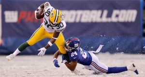 EAST RUTHERFORD, NEW JERSEY - DECEMBER 01: Jamaal Williams #30 of the Green Bay Packers is tackled by Julian Love #24 of the New York Giants in the third quarter at MetLife Stadium on December 01, 2019 in East Rutherford, New Jersey.The Green Bay Packers defeated the New York Giants 31-13.