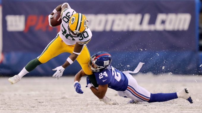 EAST RUTHERFORD, NEW JERSEY - DECEMBER 01: Jamaal Williams #30 of the Green Bay Packers is tackled by Julian Love #24 of the New York Giants in the third quarter at MetLife Stadium on December 01, 2019 in East Rutherford, New Jersey.The Green Bay Packers defeated the New York Giants 31-13.