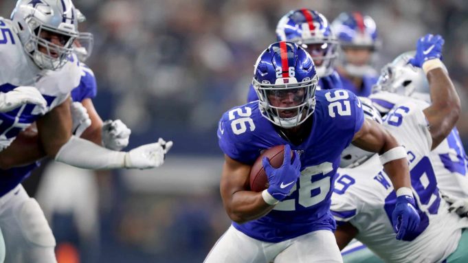 ARLINGTON, TEXAS - SEPTEMBER 08: Saquon Barkley #26 of the New York Giants carries the ball against Chidobe Awuzie #24 of the Dallas Cowboys in the third quarter at AT&T Stadium on September 08, 2019 in Arlington, Texas.