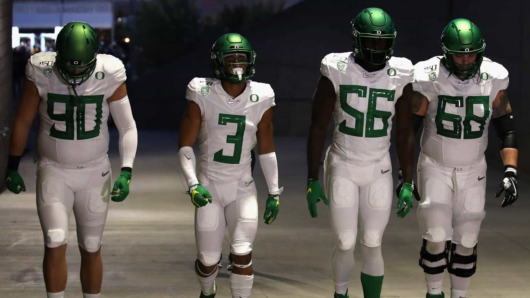 TEMPE, ARIZONA - NOVEMBER 23: (L-R) Defensive tackle Drayton Carlberg #90, wide receiver Johnny Johnson III #3, linebacker Bryson Young #56 and offensive lineman Shane Lemieux #68 of the Oregon Ducks walk to the field before the NCAAF game against the Arizona State Sun Devils at Sun Devil Stadium on November 23, 2019 in Tempe, Arizona.