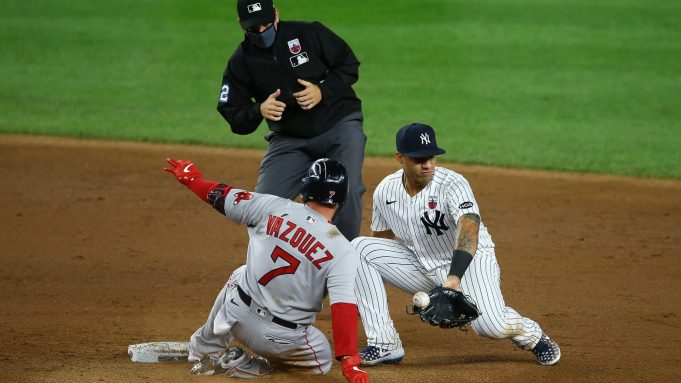 NEW YORK, NEW YORK - AUGUST 16: Christian Vazquez #7 of the Boston Red Sox slides in for a double as the ball get by Gleyber Torres #25 of the New York Yankees in the ninth inning at Yankee Stadium on August 16, 2020 in New York City.