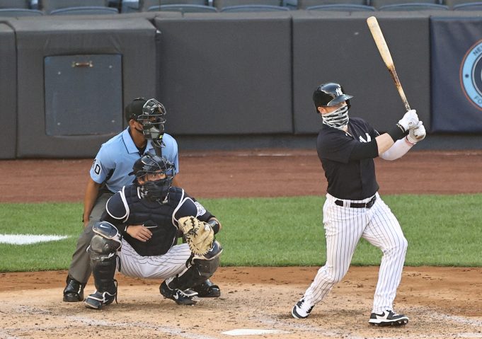 NEW YORK, NEW YORK - JULY 14: Clint Frazier #77 of the New York Yankees takes his at bat as Kyle Higashioka #66 of the New York Yankees catches during an intrasquad game of summer workouts at Yankee Stadium on July 14, 2020 in the Bronx borough of New York City.Both players wore face coverings.