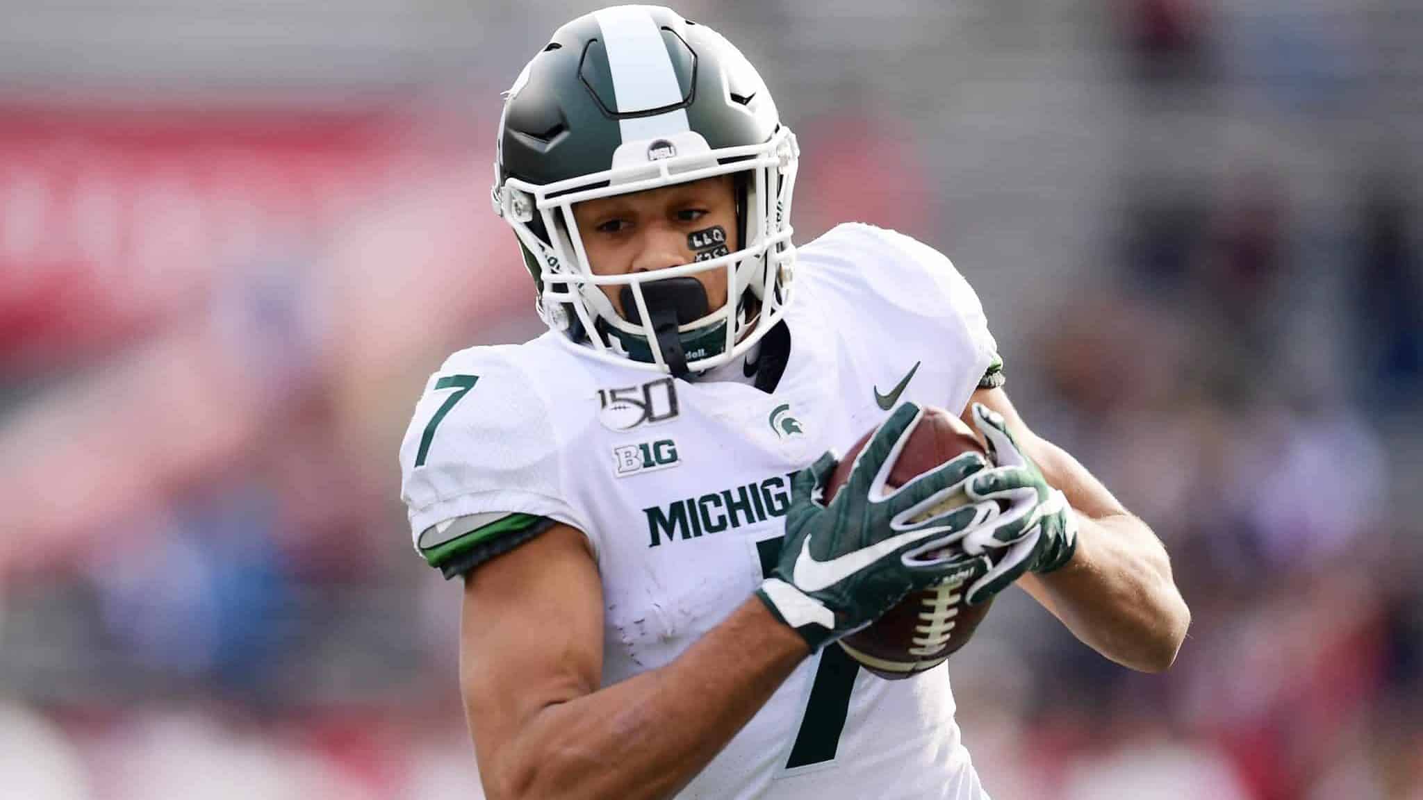 PISCATAWAY, NEW JERSEY - NOVEMBER 23: Cody White #7 of the Michigan State Spartans runs the ball in the second half of their game against the Rutgers Scarlet Knights at SHI Stadium on November 23, 2019 in Piscataway, New Jersey.