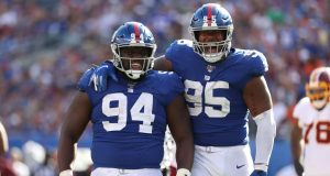 EAST RUTHERFORD, NEW JERSEY - SEPTEMBER 29: Dalvin Tomlinson #94 and B.J. Hill #95 of the New York Giants celebrates a sack of Dwayne Haskins #7 of the Washington Redskins during their game at MetLife Stadium on September 29, 2019 in East Rutherford, New Jersey.