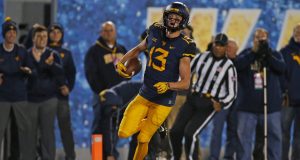 MORGANTOWN, WV - OCTOBER 25: David Sills V #13 of the West Virginia Mountaineers celebrates after catching a 65 yard touchdown pass in the first half against the Baylor Bears at Mountaineer Field on October 25, 2018 in Morgantown, West Virginia.