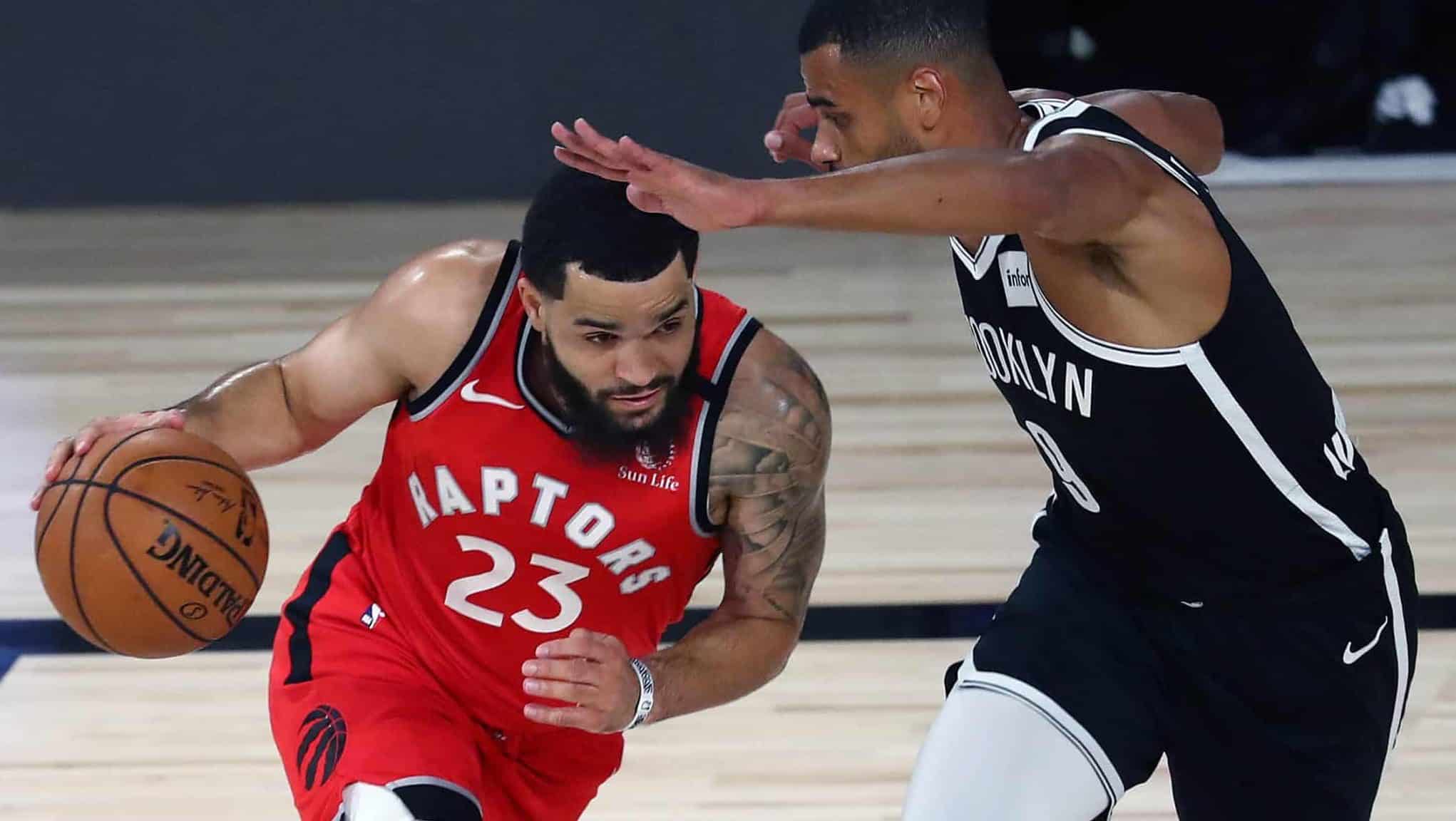 LAKE BUENA VISTA, FLORIDA - AUGUST 23: Fred VanVleet #23 of the Toronto Raptors moves the ball against Timothe Luwawu-Cabarrot #9 of the Brooklyn Nets during the first half in game four of the first round of the NBA playoffs at The Field House at ESPN Wide World Of Sports Complex on August 23, 2020 in Lake Buena Vista, Florida. NOTE TO USER: User expressly acknowledges and agrees that, by downloading and or using this photograph, User is consenting to the terms and conditions of the Getty Images License Agreement.