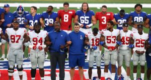 EAST RUTHERFORD, NEW JERSEY - AUGUST 28: New York Giants lock arms in a pregame moment of silence prior to the start of the Blue and White scrimmage at MetLife Stadium on August 28, 2020 in East Rutherford, New Jersey.