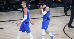 LAKE BUENA VISTA, FLORIDA - AUGUST 21: Kristaps Porzingis #6 and Luka Doncic #77 of the Dallas Mavericks leave the court after the first half of Game Three of the first round of the playoffs at the AdventHealth Arena at the ESPN Wide World Of Sports Complex on August 21, 2020 in Lake Buena Vista, Florida. NOTE TO USER: User expressly acknowledges and agrees that, by downloading and or using this photograph, User is consenting to the terms and conditions of the Getty Images License Agreement.