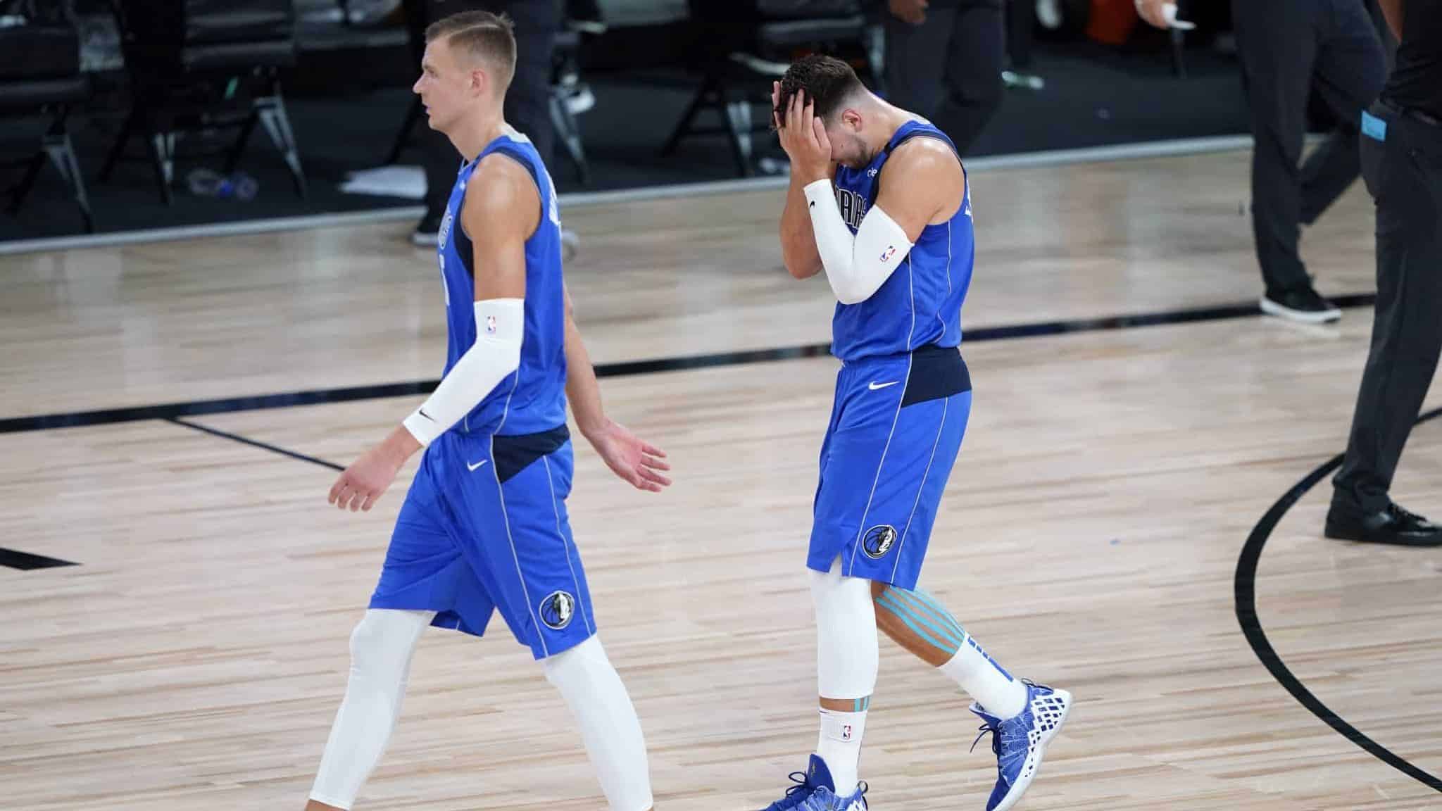 LAKE BUENA VISTA, FLORIDA - AUGUST 21: Kristaps Porzingis #6 and Luka Doncic #77 of the Dallas Mavericks leave the court after the first half of Game Three of the first round of the playoffs at the AdventHealth Arena at the ESPN Wide World Of Sports Complex on August 21, 2020 in Lake Buena Vista, Florida. NOTE TO USER: User expressly acknowledges and agrees that, by downloading and or using this photograph, User is consenting to the terms and conditions of the Getty Images License Agreement.