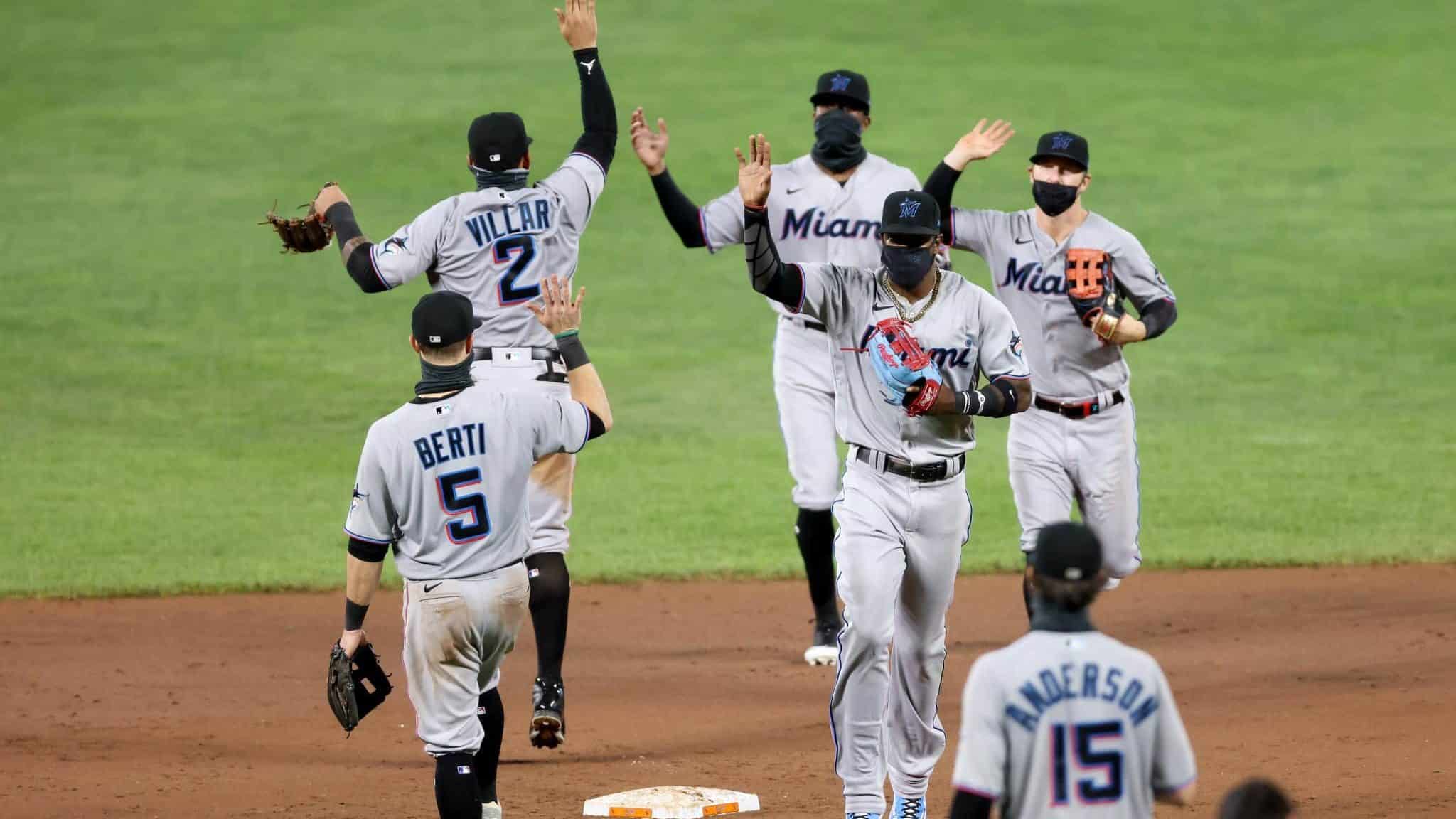 BALTIMORE, MARYLAND - AUGUST 04: Members of the Miami Marlins celebrate their 4-0 win over the Baltimore Orioles at Oriole Park at Camden Yards on August 04, 2020 in Baltimore, Maryland.