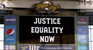 MILWAUKEE, WISCONSIN - AUGUST 25: The scoreboard displays a message of "Justice Equality Now" before the game between the Cincinnati Reds and Milwaukee Brewers at Miller Park on August 25, 2020 in Milwaukee, Wisconsin.