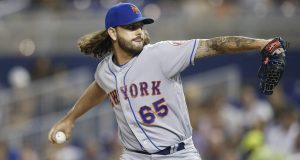 MIAMI, FLORIDA - JULY 12: Robert Gsellman #65 of the New York Mets delivers a pitch in the sixth inning against the Miami Marlins at Marlins Park on July 12, 2019 in Miami, Florida.
