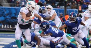 EAST RUTHERFORD, NEW JERSEY - DECEMBER 15: Patrick Laird #42 of the Miami Dolphins is tackled for a safety by Sam Beal #23 of the New York Giants in the third quarter during their game at MetLife Stadium on December 15, 2019 in East Rutherford, New Jersey.
