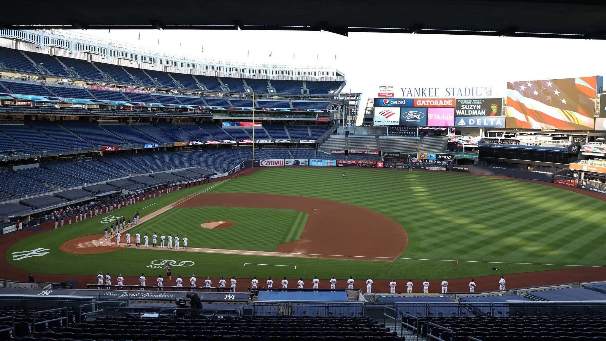 NEW YORK, NEW YORK - JULY 31: The New York Yankees and the Boston Red Sox stand for the national anthem during their home opener at Yankee Stadium on July 31, 2020 in New York City. The 2020 season had been postponed since March due to the COVID-19 pandemic.