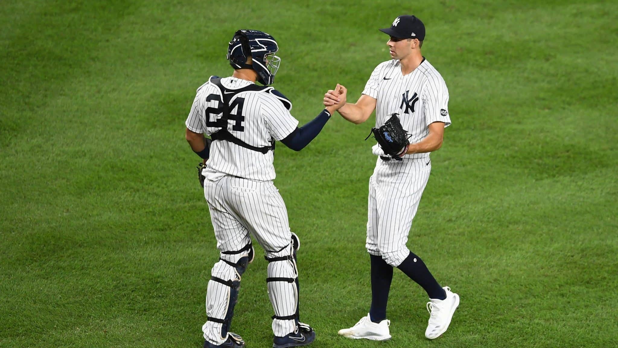 NEW YORK, NEW YORK - AUGUST 14: Ben Heller #61 celebrates with Gary Sanchez #24 of the New York Yankees during the ninth inning against the Boston Red Sox at Yankee Stadium on August 14, 2020 in the Bronx borough of New York City. The Yankees won 10-3.