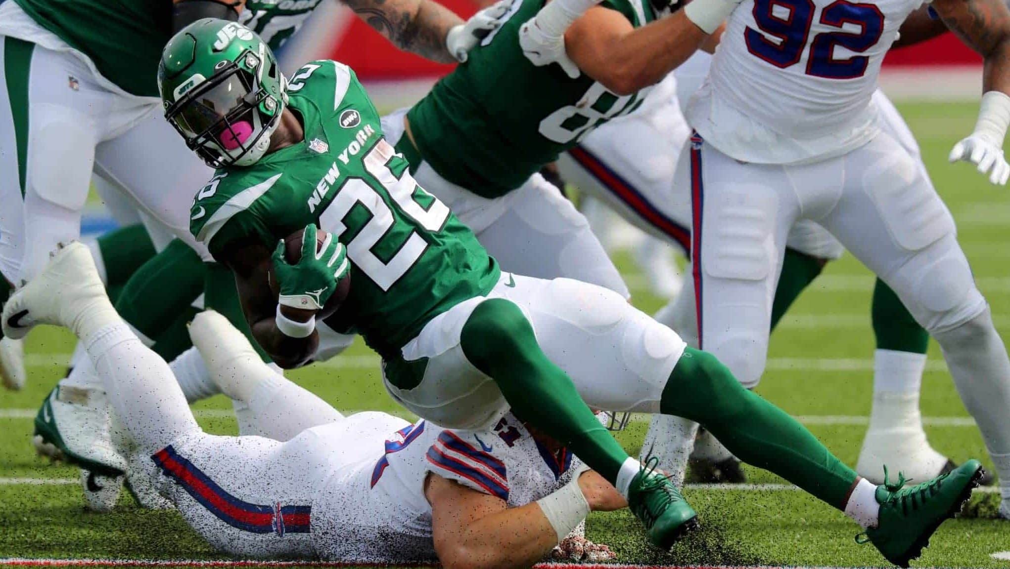 ORCHARD PARK, NY - SEPTEMBER 13: Justin Zimmer #61 of the Buffalo Bills dives to make a tackle on Le'Veon Bell #26 of the New York Jets during the first quarter at Bills Stadium on September 13, 2020 in Orchard Park, New York.