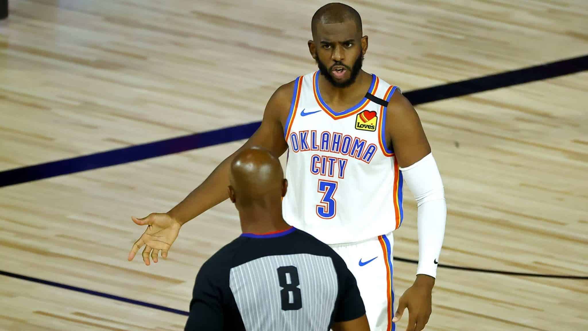 LAKE BUENA VISTA, FLORIDA - AUGUST 05: Chris Paul #3 of the Oklahoma City Thunder discusses a call with referee Marc Davis #8 during the second quarter against the Los Angeles Lakers at HP Field House at ESPN Wide World Of Sports Complex on August 05, 2020 in Lake Buena Vista, Florida. NOTE TO USER: User expressly acknowledges and agrees that, by downloading and or using this photograph, User is consenting to the terms and conditions of the Getty Images License Agreement.