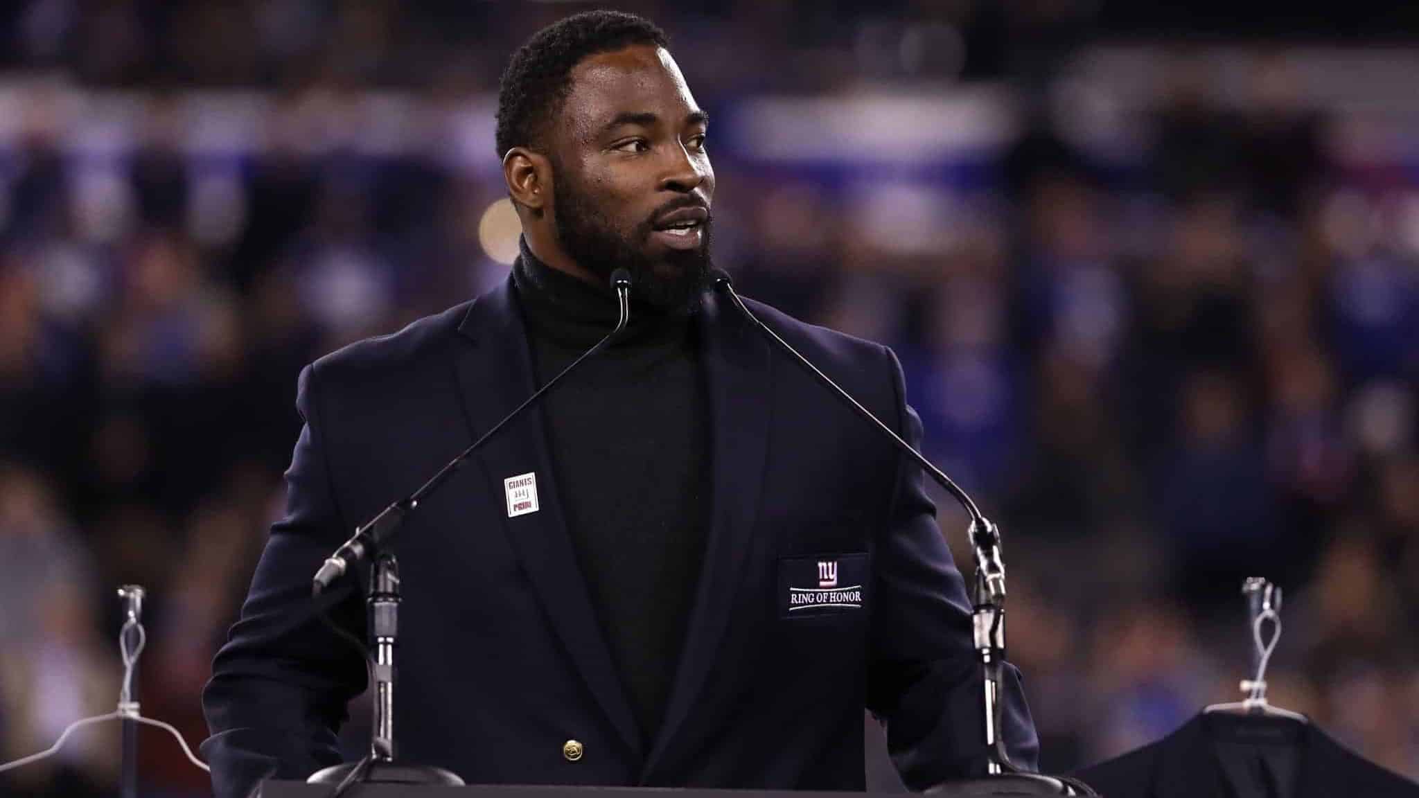 EAST RUTHERFORD, NJ - NOVEMBER 14: 2016 Giants Ring of Honor Inductee Justin Tuck speaks during the halftime ceremony of the game between the Cincinnati Bengals and the New York Giants at MetLife Stadium on November 14, 2016 in East Rutherford, New Jersey.