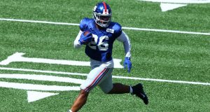 EAST RUTHERFORD, NEW JERSEY - SEPTEMBER 03: Saquon Barkley #26 of the New York Giants scores a touchdown during the Blue and White scrimmage at MetLife Stadium on September 03, 2020 in East Rutherford, New Jersey.