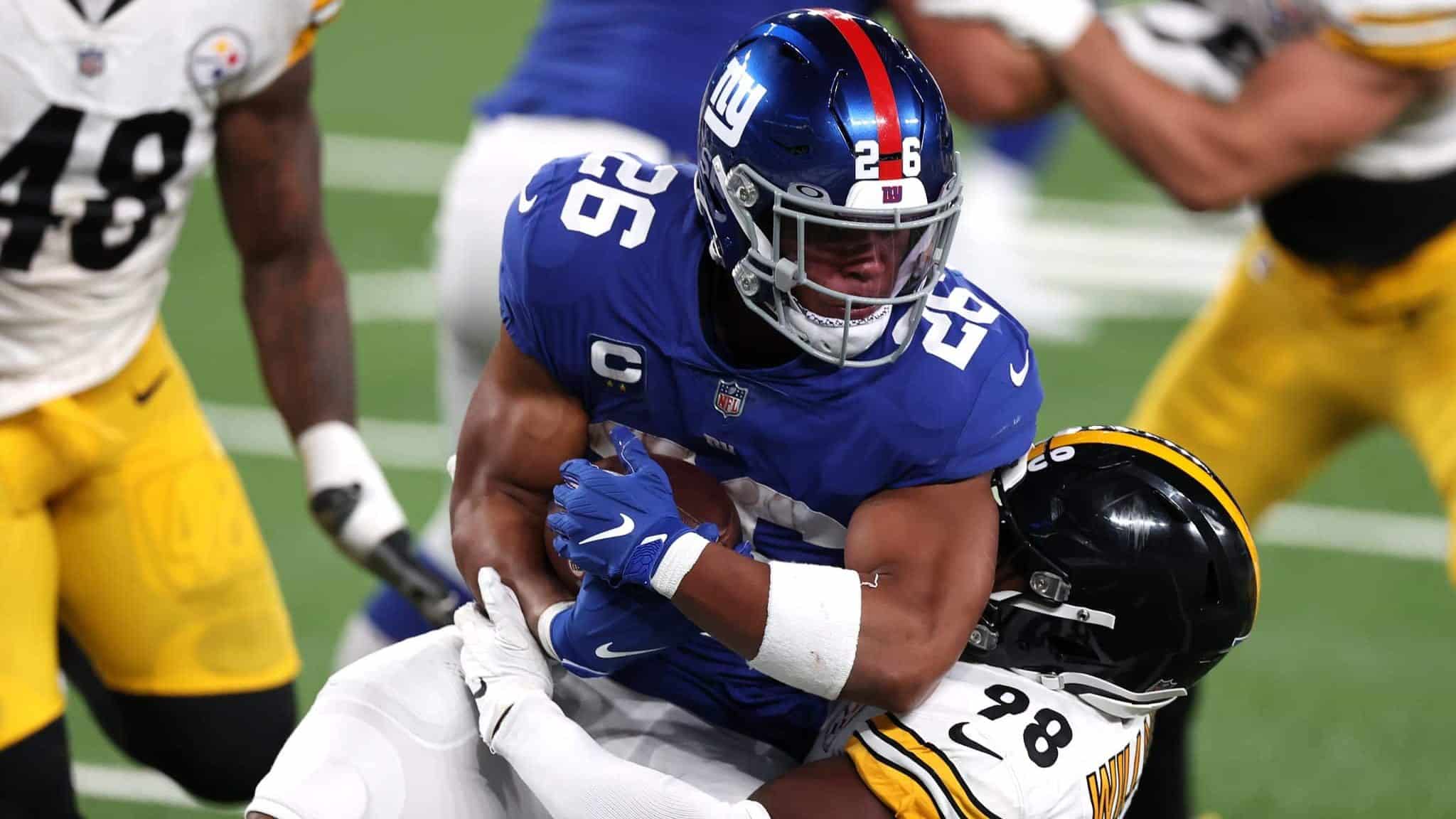 EAST RUTHERFORD, NEW JERSEY - SEPTEMBER 14: Saquon Barkley #26 of the New York Giants gets tackled by Vince Williams #98 of the Pittsburgh Steelers during the third quarter in the game at MetLife Stadium on September 14, 2020 in East Rutherford, New Jersey.